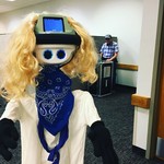 Student and robot attending the Frisco Campus Makerspace Grand Opening