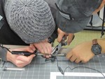 Students collaborating on a soldering project- November 2018
